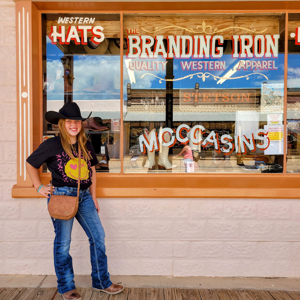 Young girl wearing her first black Stetson hat