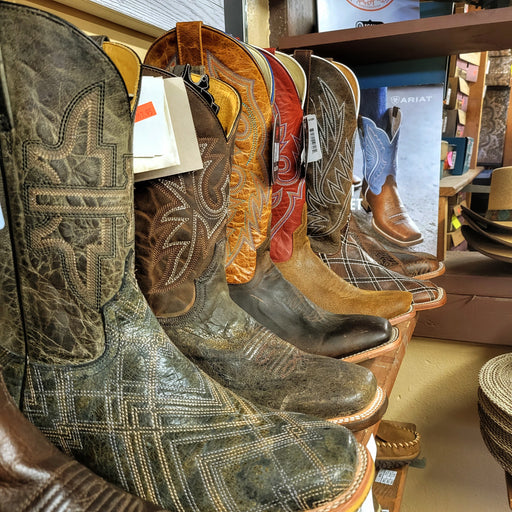 Row of men's leather western boots.