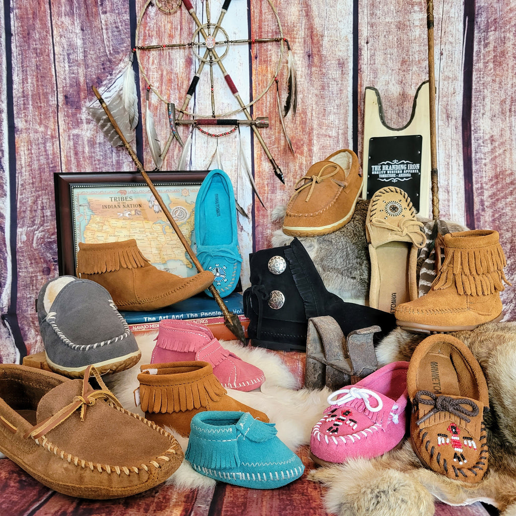 a selection of minnetonka moccasins in various sizes, styles and colors 