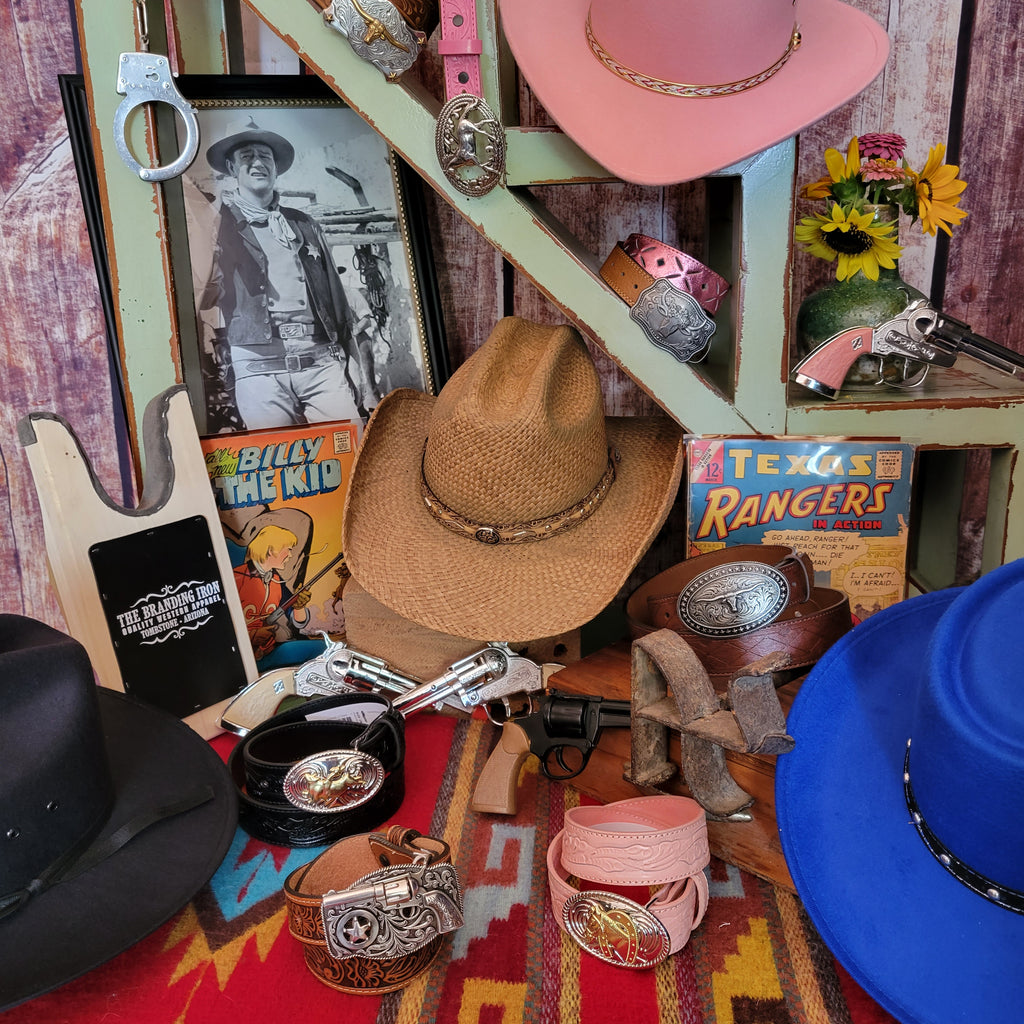 a selection of western hats, belts and items for kids