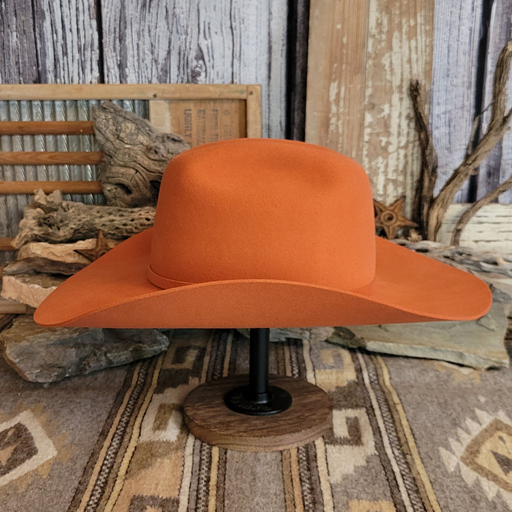 Orange wool felt hat with a sleek profile, featuring the thin band and sturdy brim.