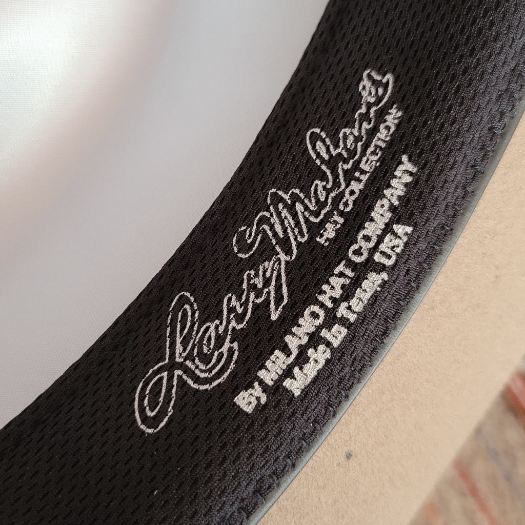 A close-up of the brand's letting and information on the sweatband.