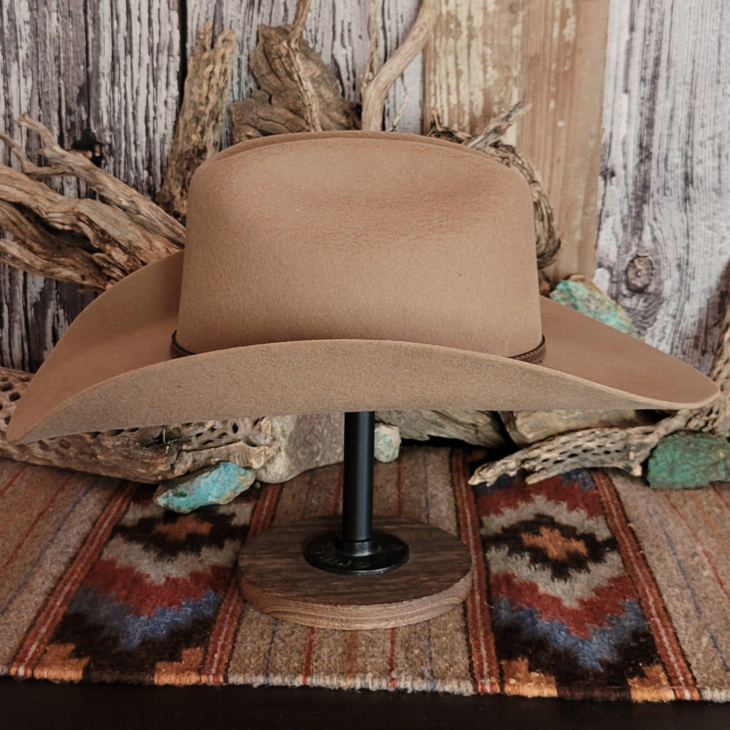 Tan wool hat with a brown leather band.