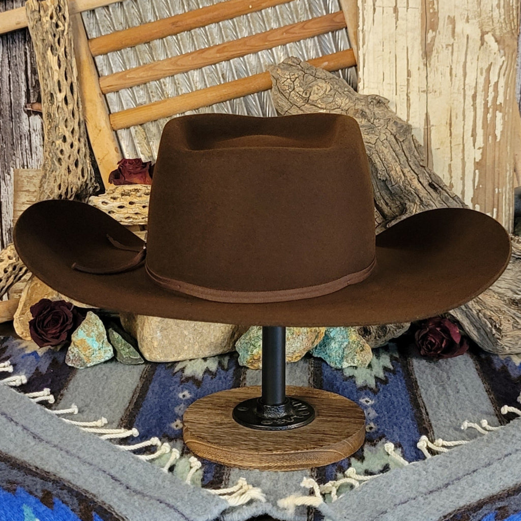 Brown wool cowboy hat with a brown band tied with a silver detail.