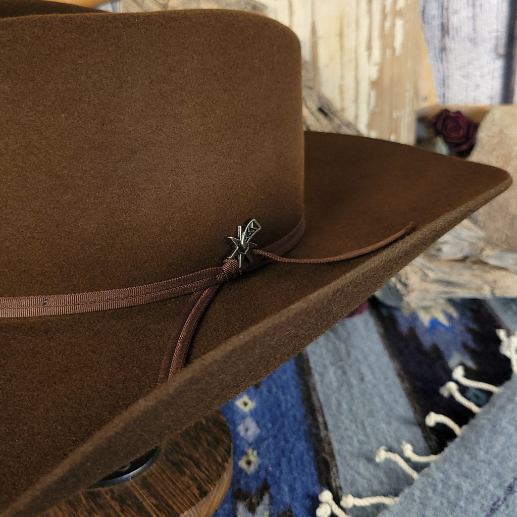 A close-up of the silver detailing tied by brown band.