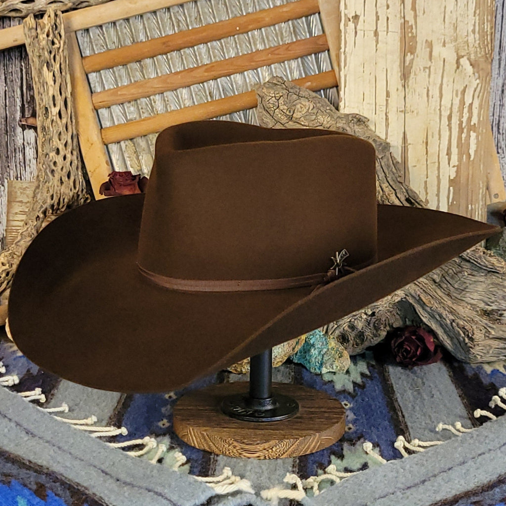 Brown wool cowboy hat with a brown band tied with a silver detail.