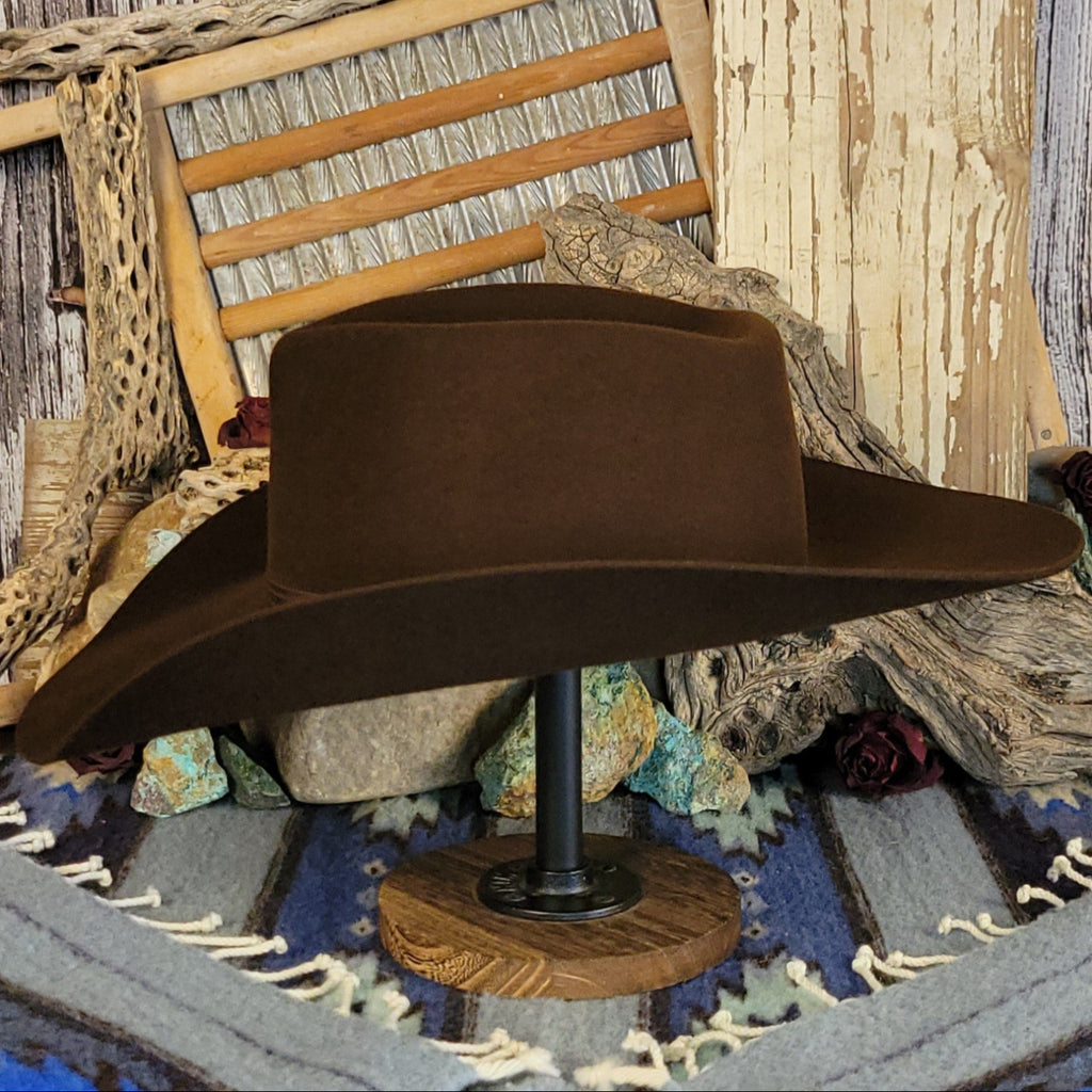 Brown wool cowboy hat with a brown band tied with a silver detail.