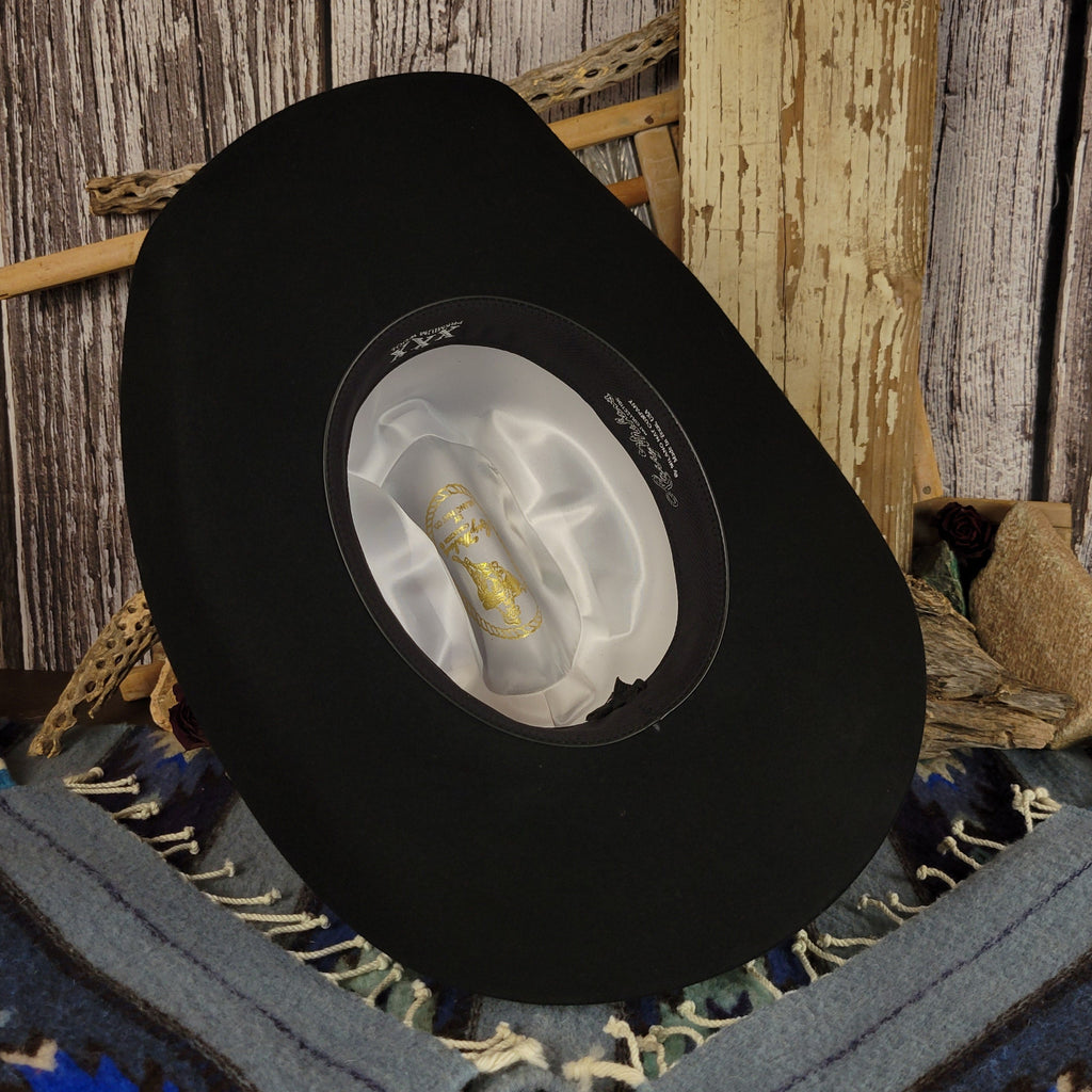 The interior features white satin with brand details and a black sweatband.
