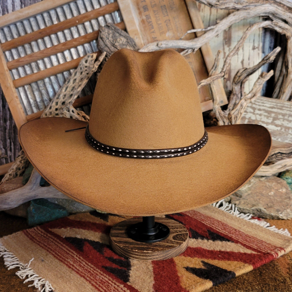 Brown cowboy hat with rustic finish and a brown and white hat band.