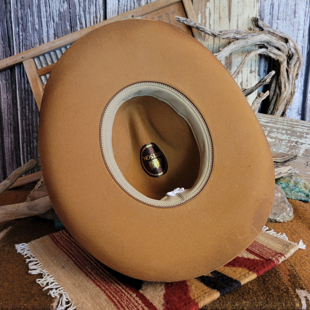 Interior of the brown cowboy hat with tan sweatband.