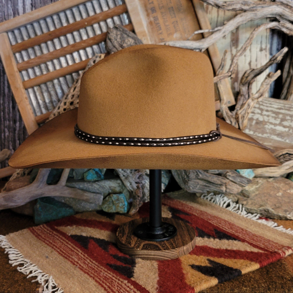 Brown cowboy hat with rustic finish and a brown and white hat band.