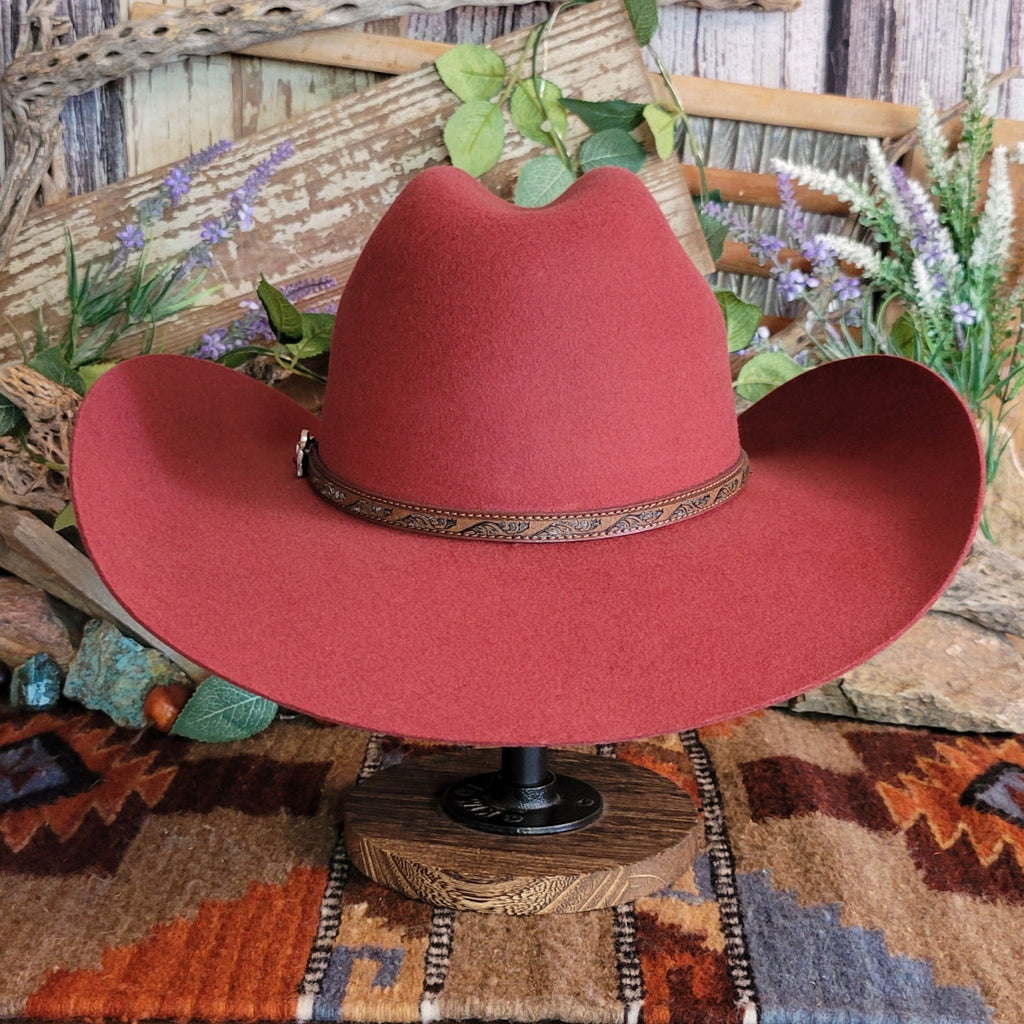 Carmine, wool cowboy hat with decorative leather hat band.