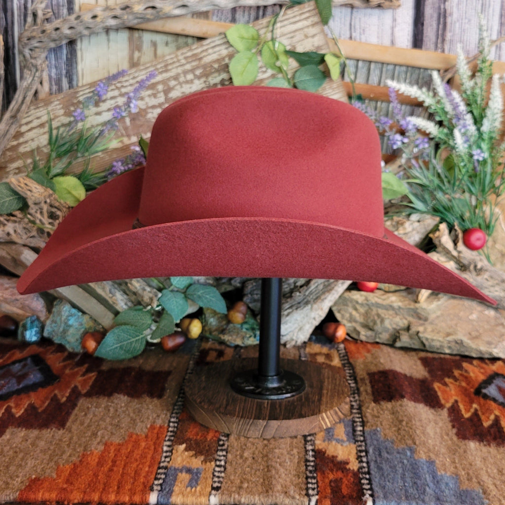 Carmine, wool cowboy hat with decorative leather hat band.