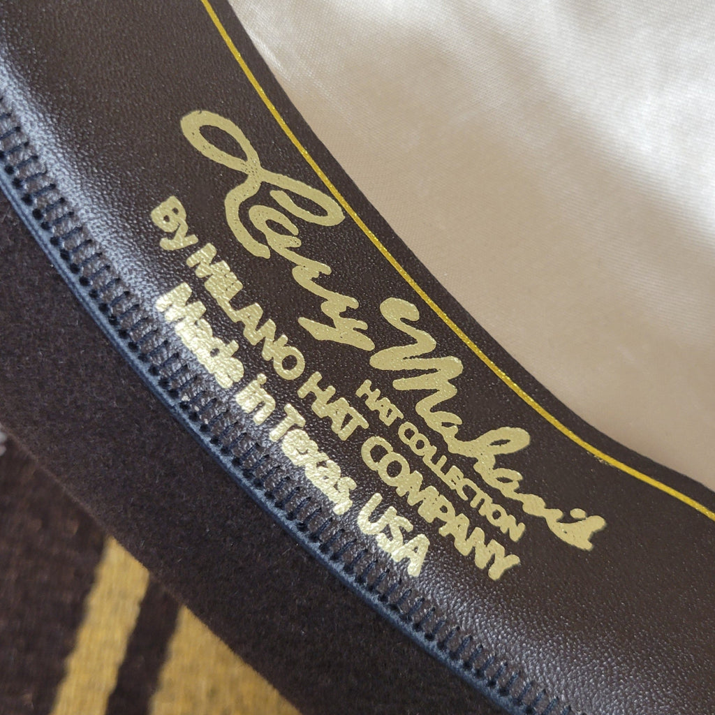 Close-up of the brand's name on the sweatband in gold lettering.