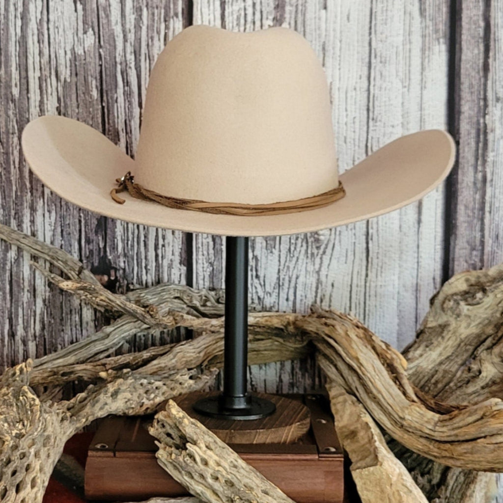 Cowboy hat in the color buckskin with a felt twine wrapped around the crown as a hat band.