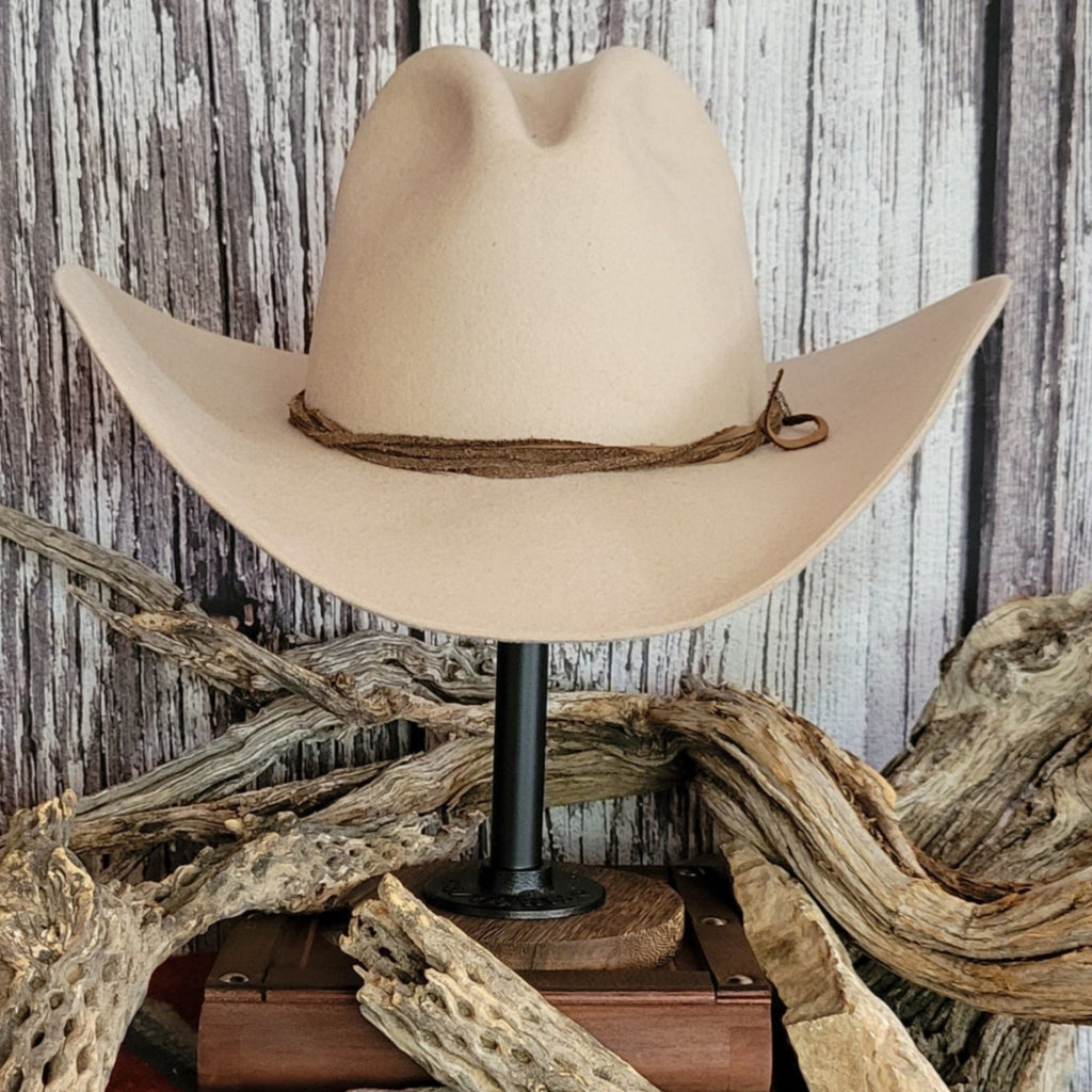 Cowboy hat in the color buckskin with a felt twine wrapped around the crown as a hat band.