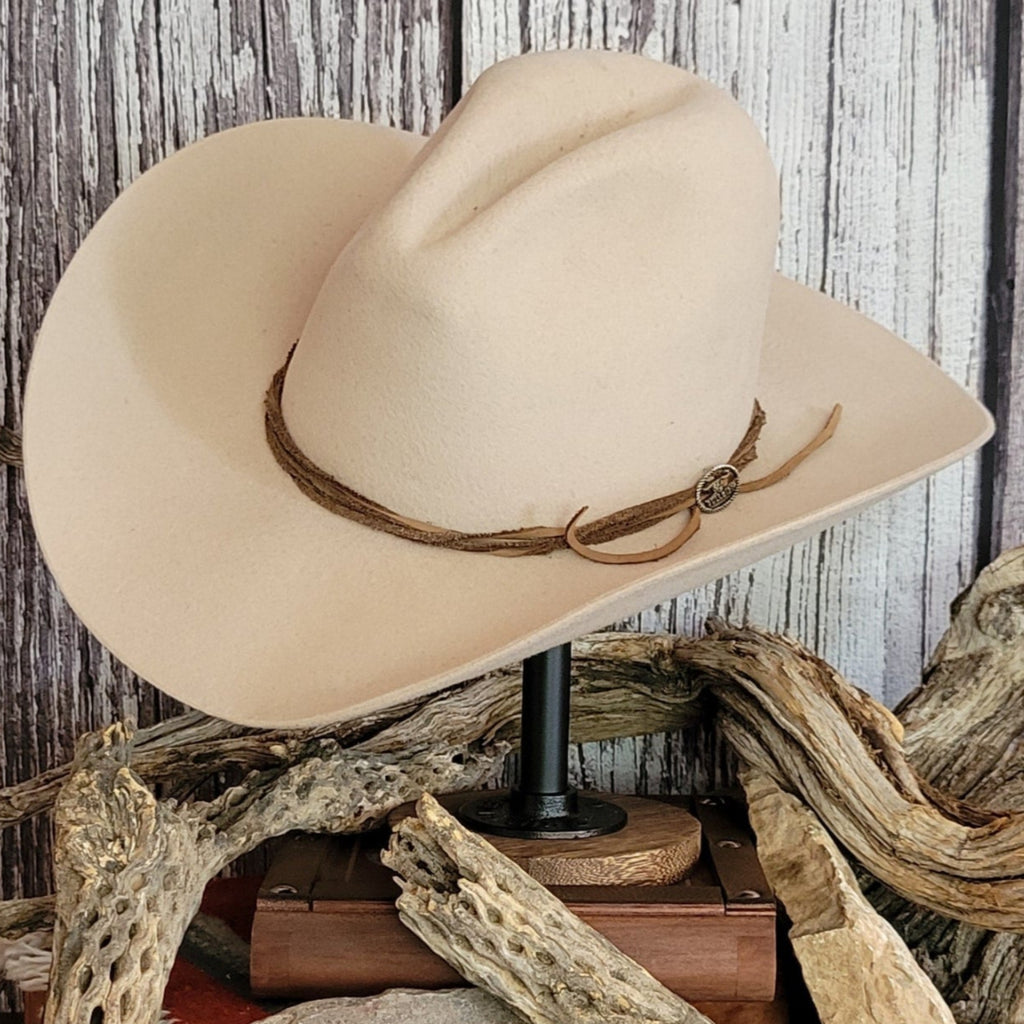 Cowboy hat in the color buckskin with a felt twine wrapped around the crown as a hat band.