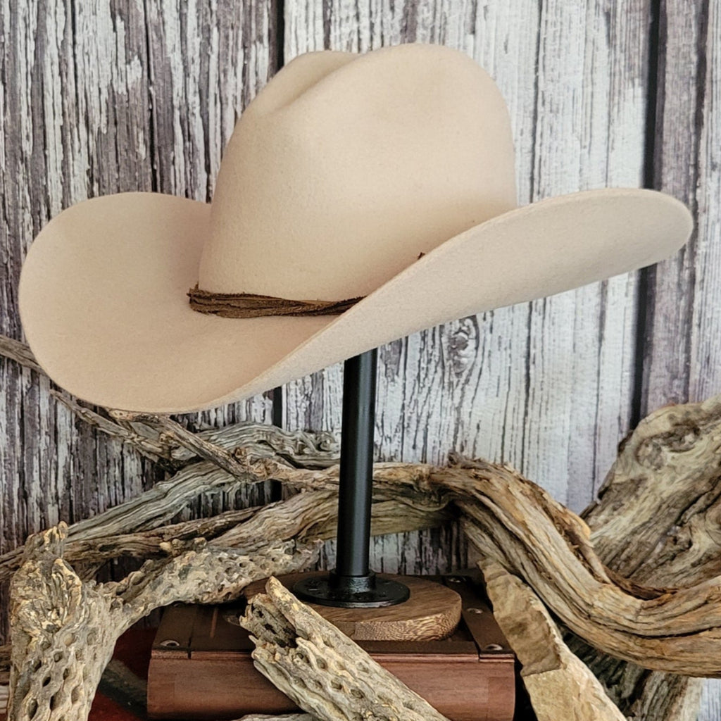 Cowboy hat in the color buckskin with a felt twine wrapped around the crown as a hat band.