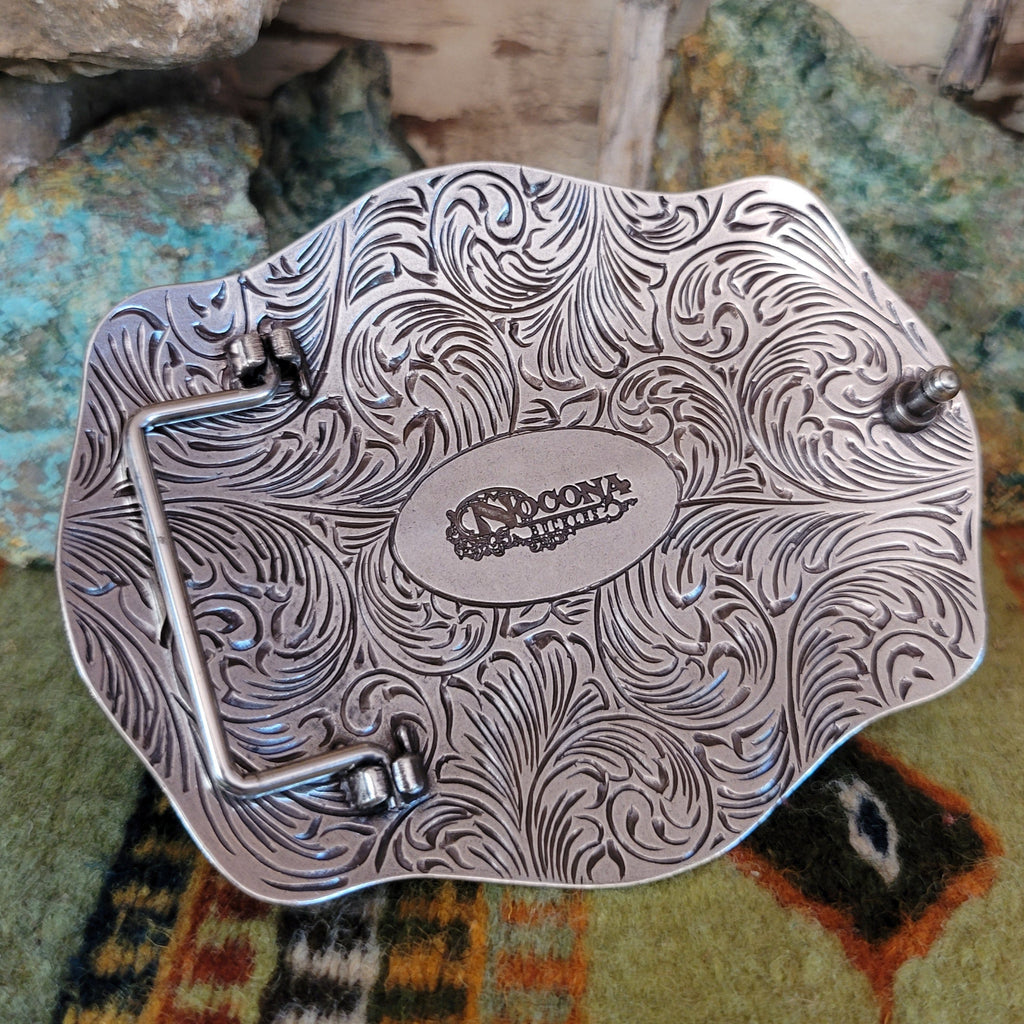 An ornate detailed buckle with the maker's mark on the underside.