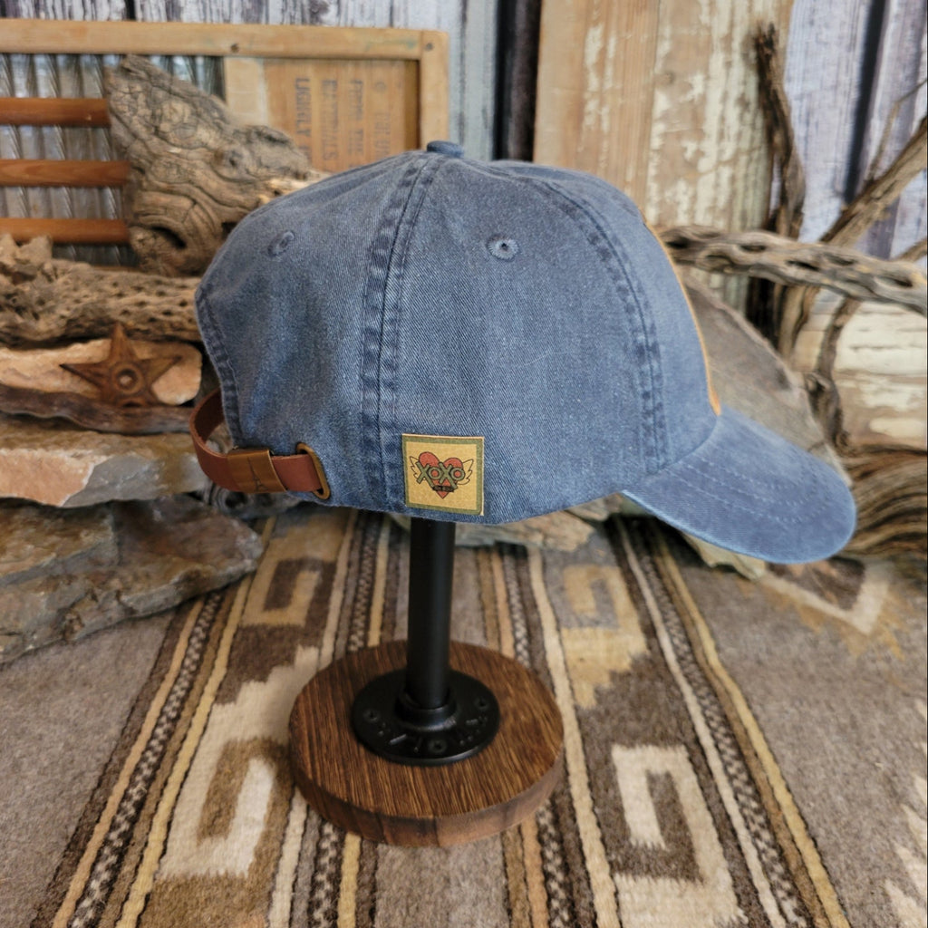 Midnight cap with a curved bill, showing distressed fabric and reinforced stitching.