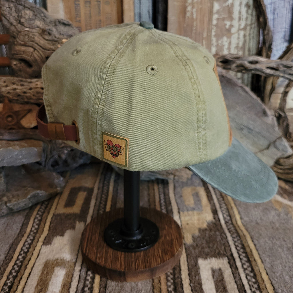 Spruce cap with a curved bill, featuring distressed cotton.