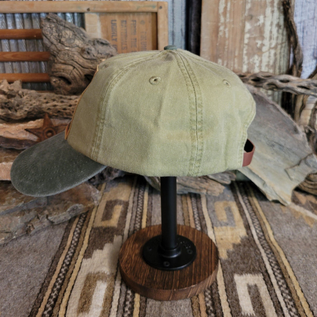Spruce cap with a curved bill, featuring distressed cotton.