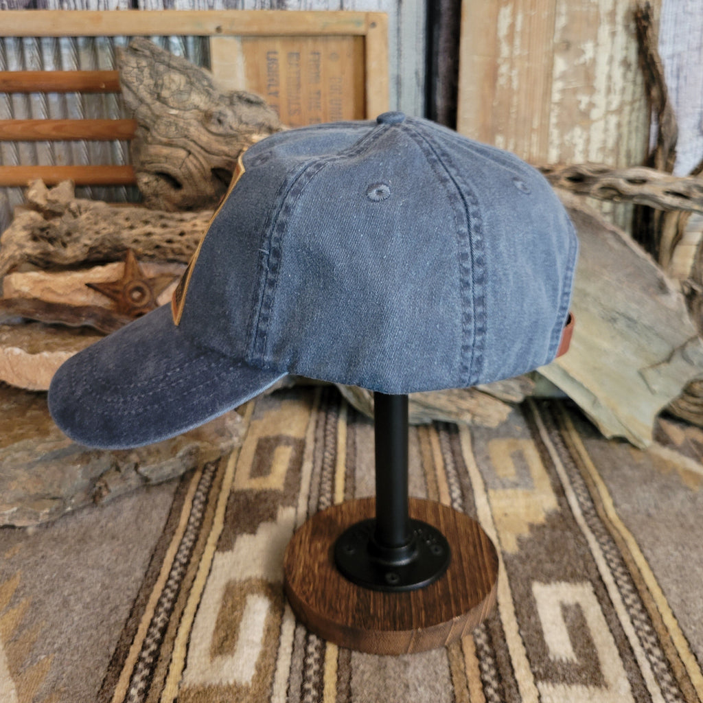 Midnight cap with a curved bill, showing distressed fabric and reinforced stitching.