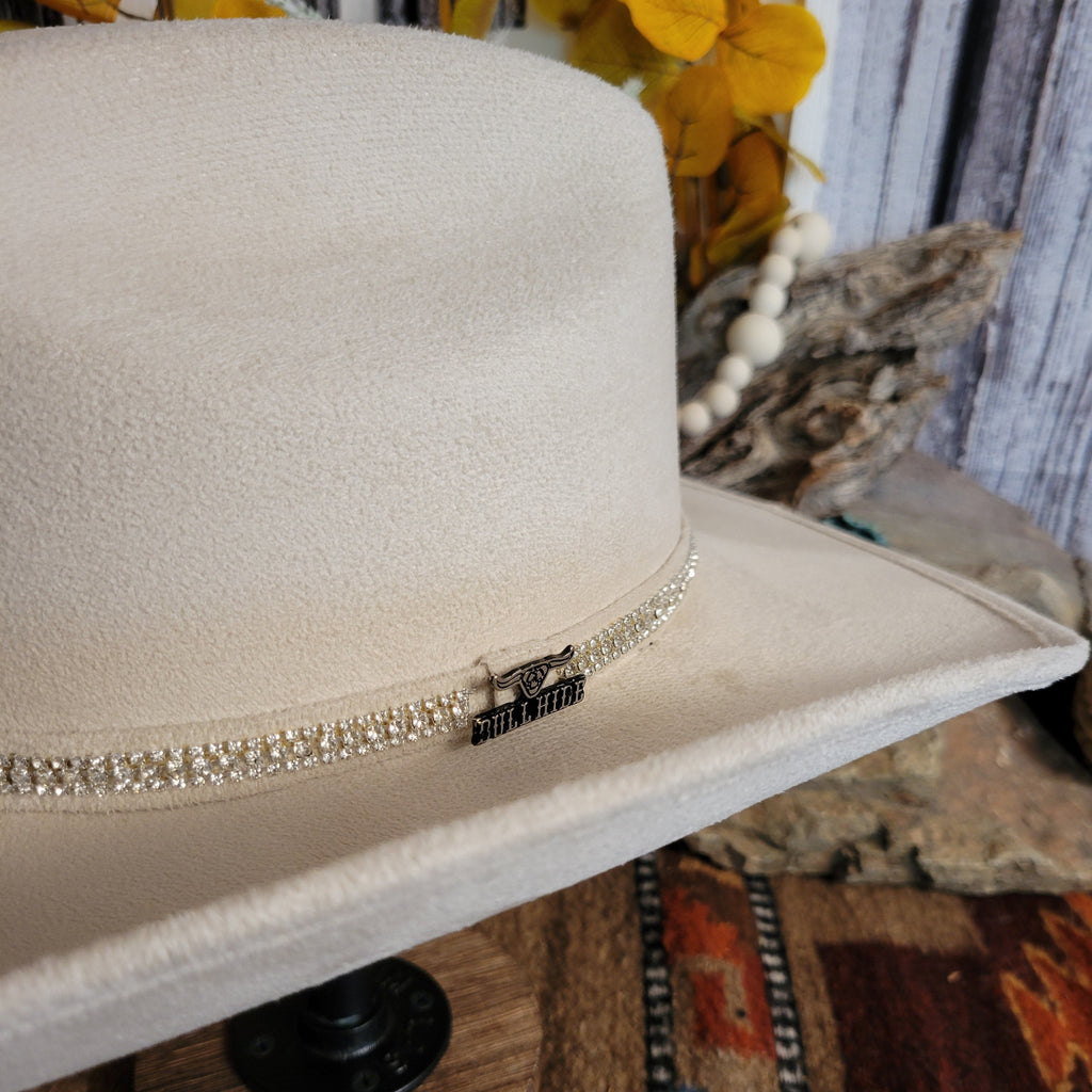 A close-up of the brand's charm found on the rhinestone hat band.