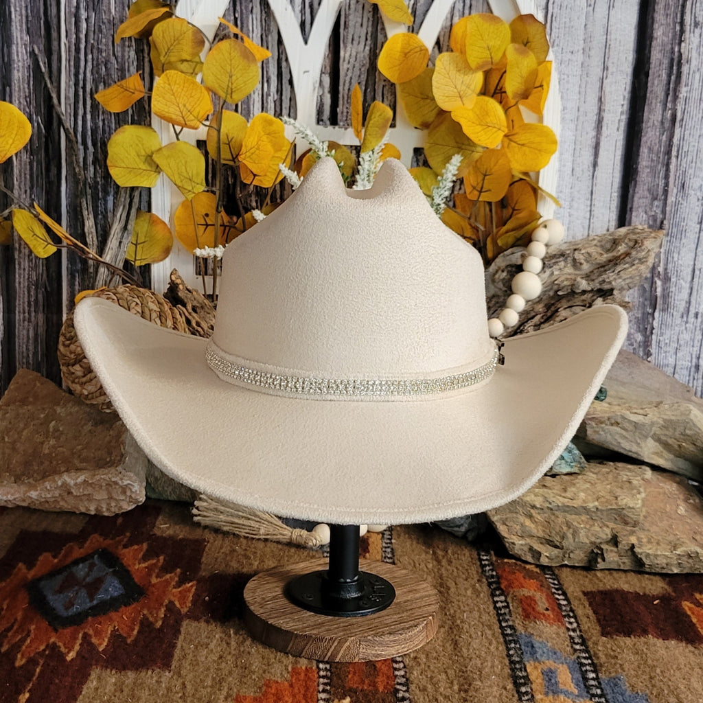 Buckskin felt hat with soft exterior and rhinestone hat band.