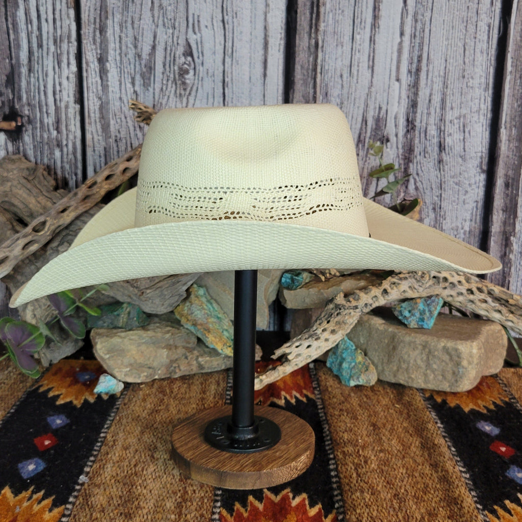 A cream straw rodeo hat curved brim and crown.