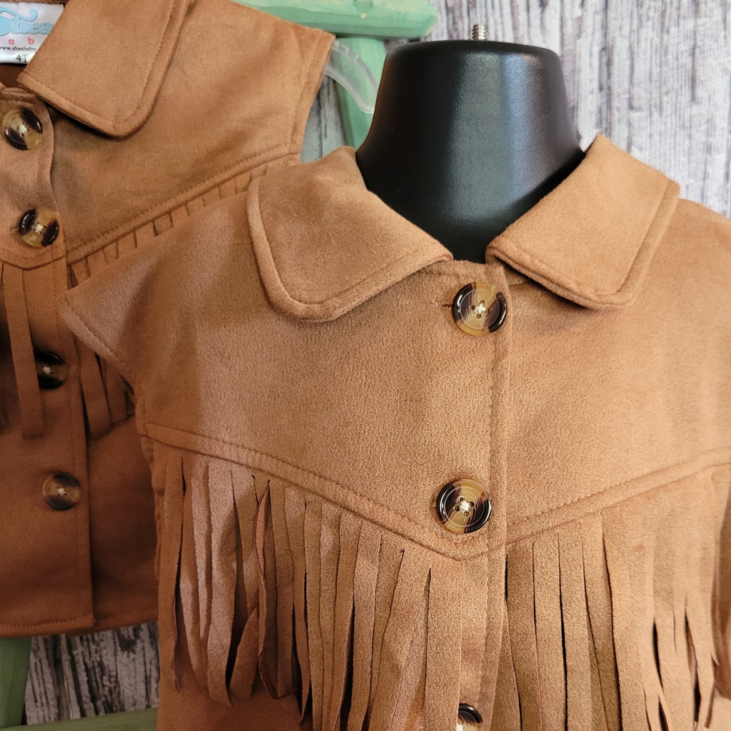 A close-up of the fringe and buttons on the front of the vest.