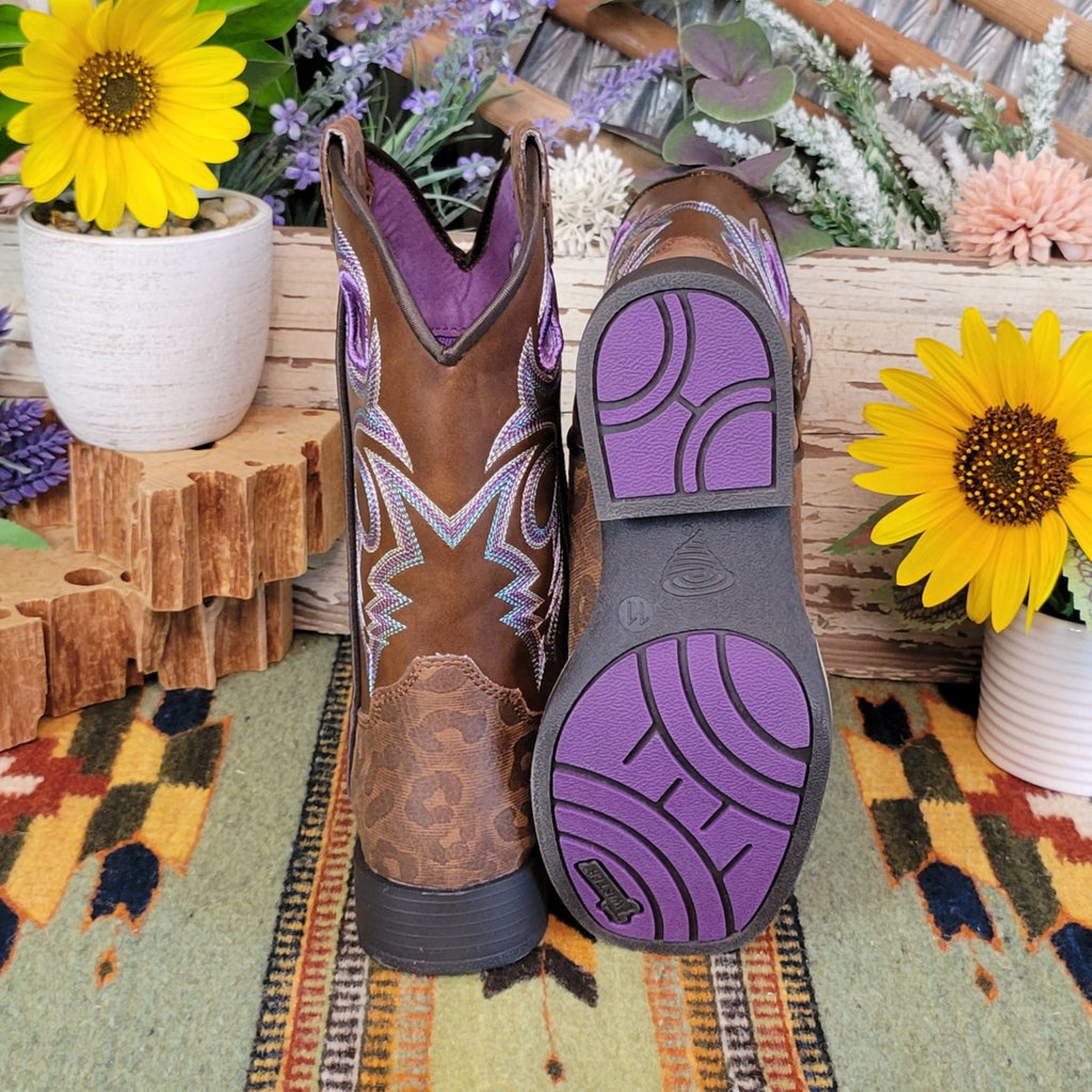 A purple sole with circular grip patterns and the leopard print on the back of the boot.