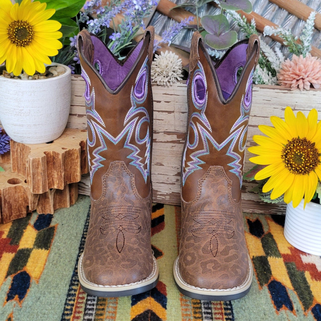 A brown faux-leather kids' boot with a leopard print pattern and purple stitched accents.