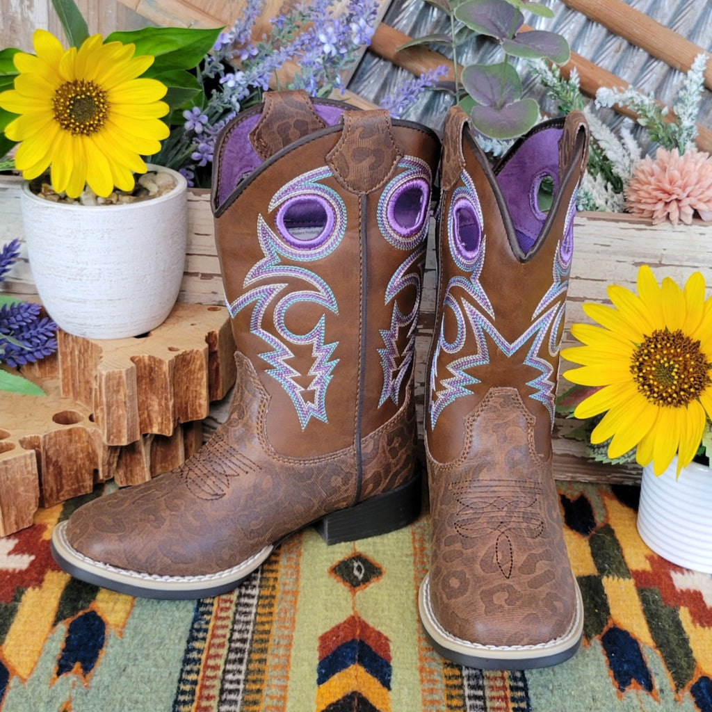 A brown faux-leather kids' boot with a leopard print pattern and purple stitched accents.