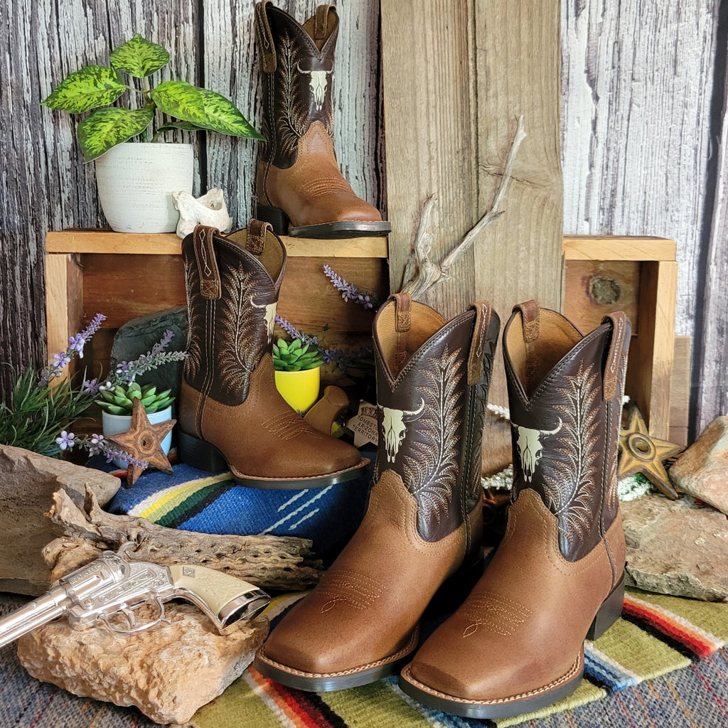 Two pairs of cowboy boots made from leather with dark brown shaft featuring a cow skull detail.