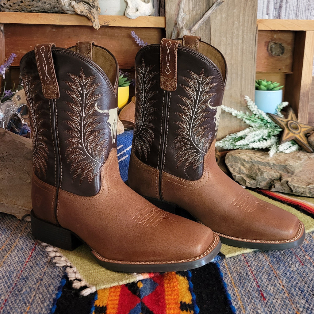 Cowboy boots made from leather with dark brown shaft featuring a cow skull detail.