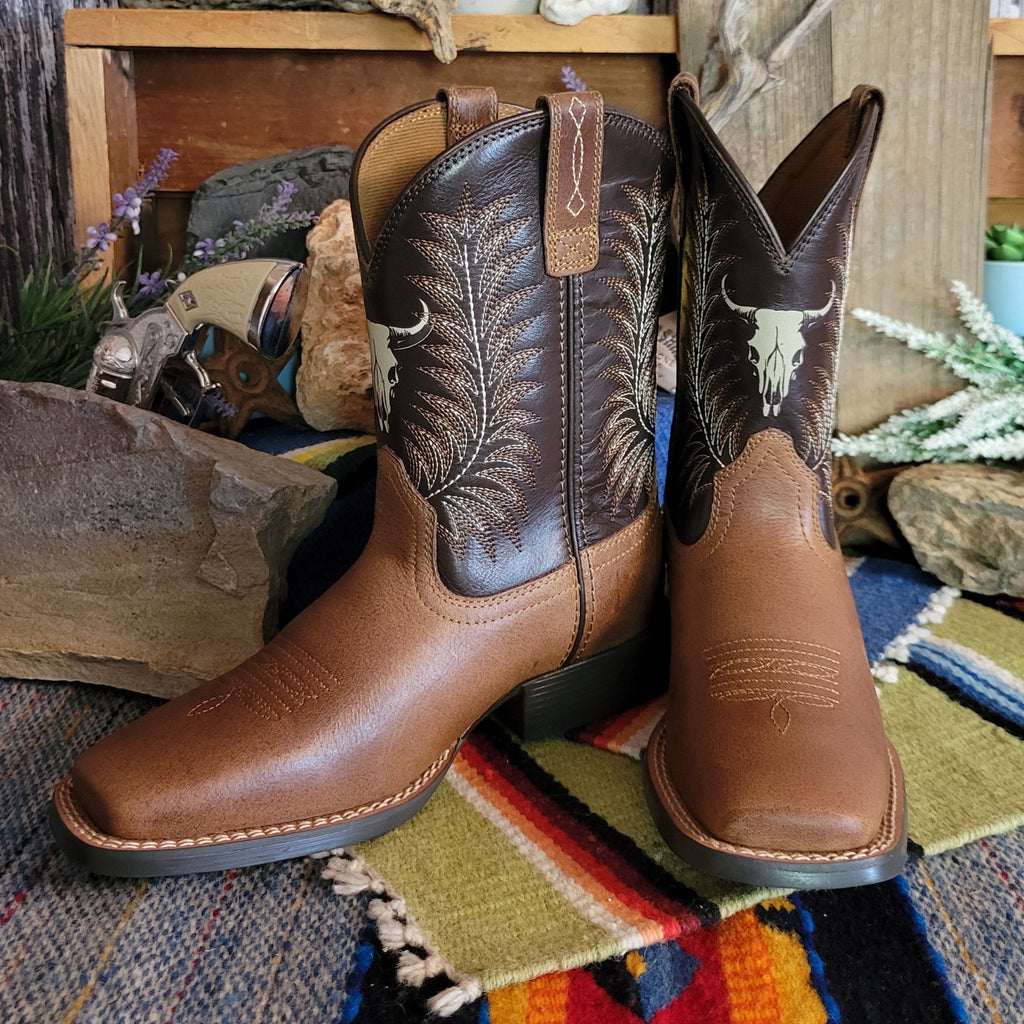 Cowboy boots made from leather with dark brown shaft featuring a cow skull detail.