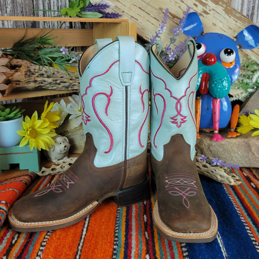 Pair of cowboy boots with teal shaft with bright red designs and dark brown leather toe.