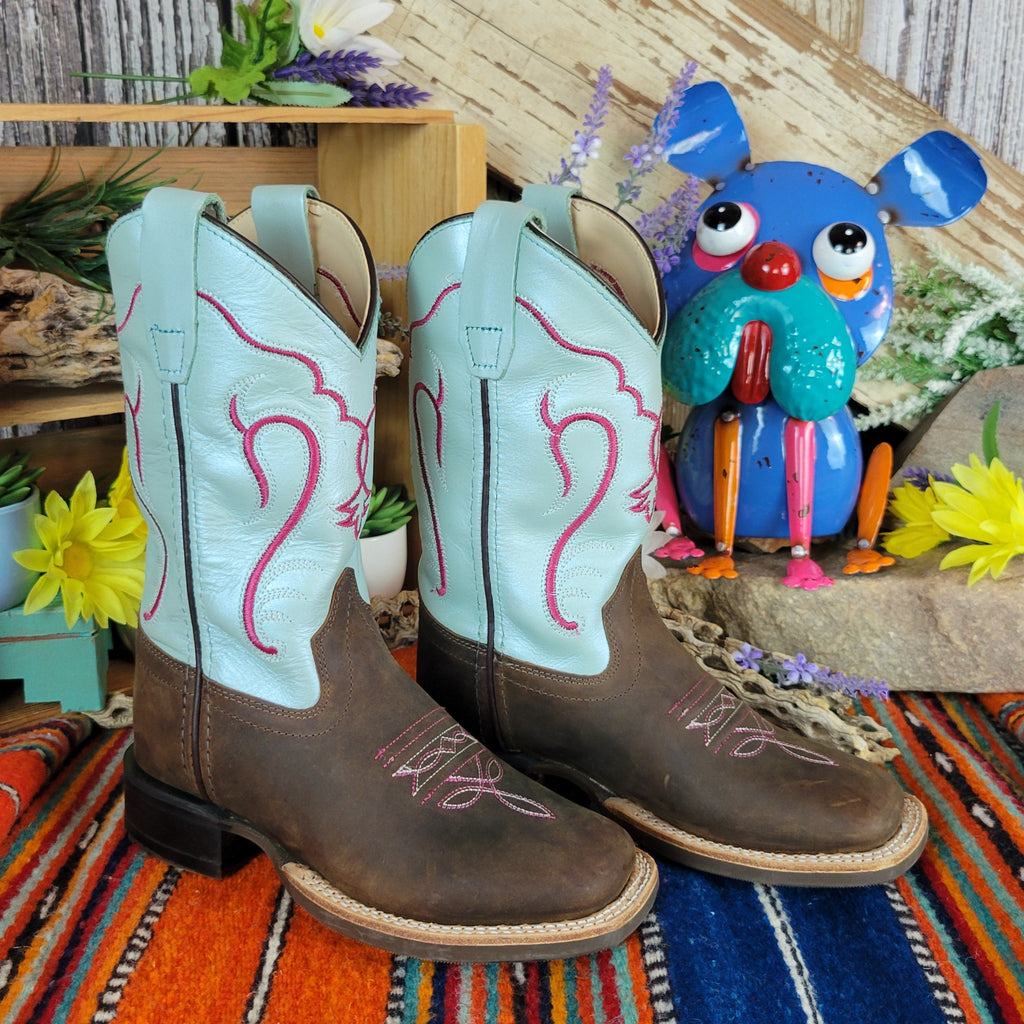 Pair of cowboy boots with teal shaft with bright red designs and dark brown leather toe.