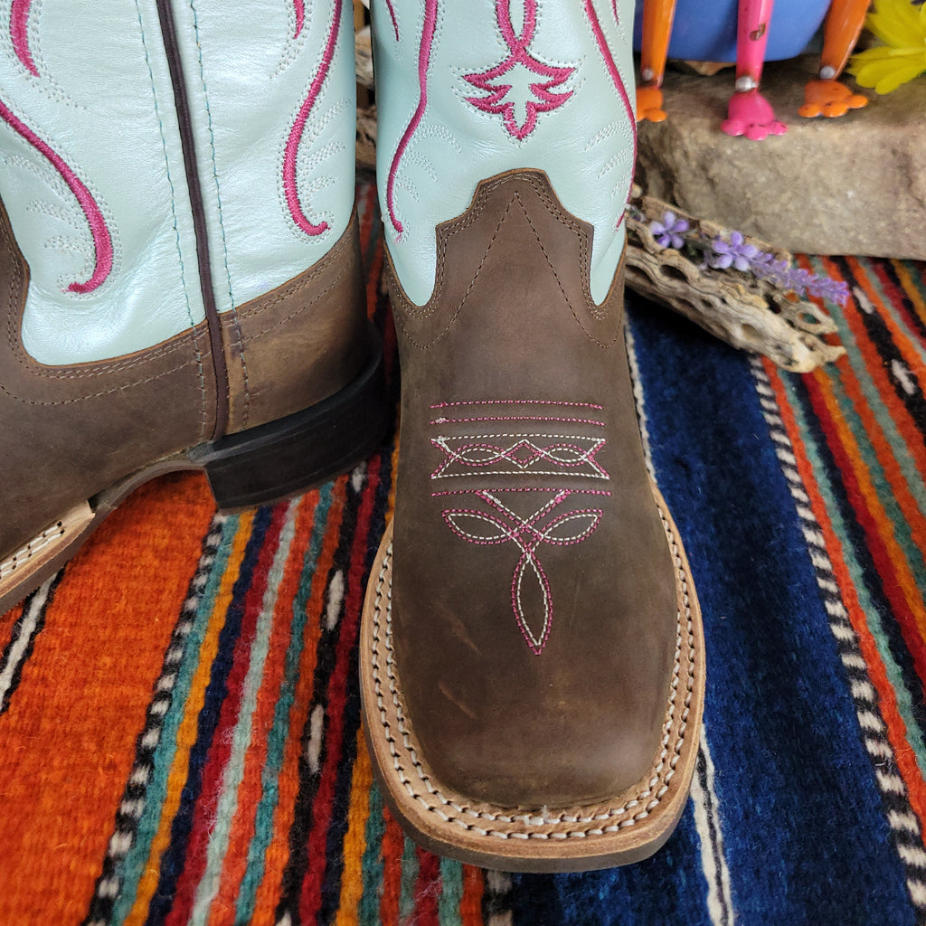 Close-up of the detailed white and red stitching on the toe.