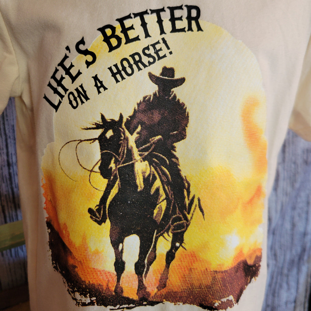 Close-up of the cowboy riding into the sunset with slogan on the front.