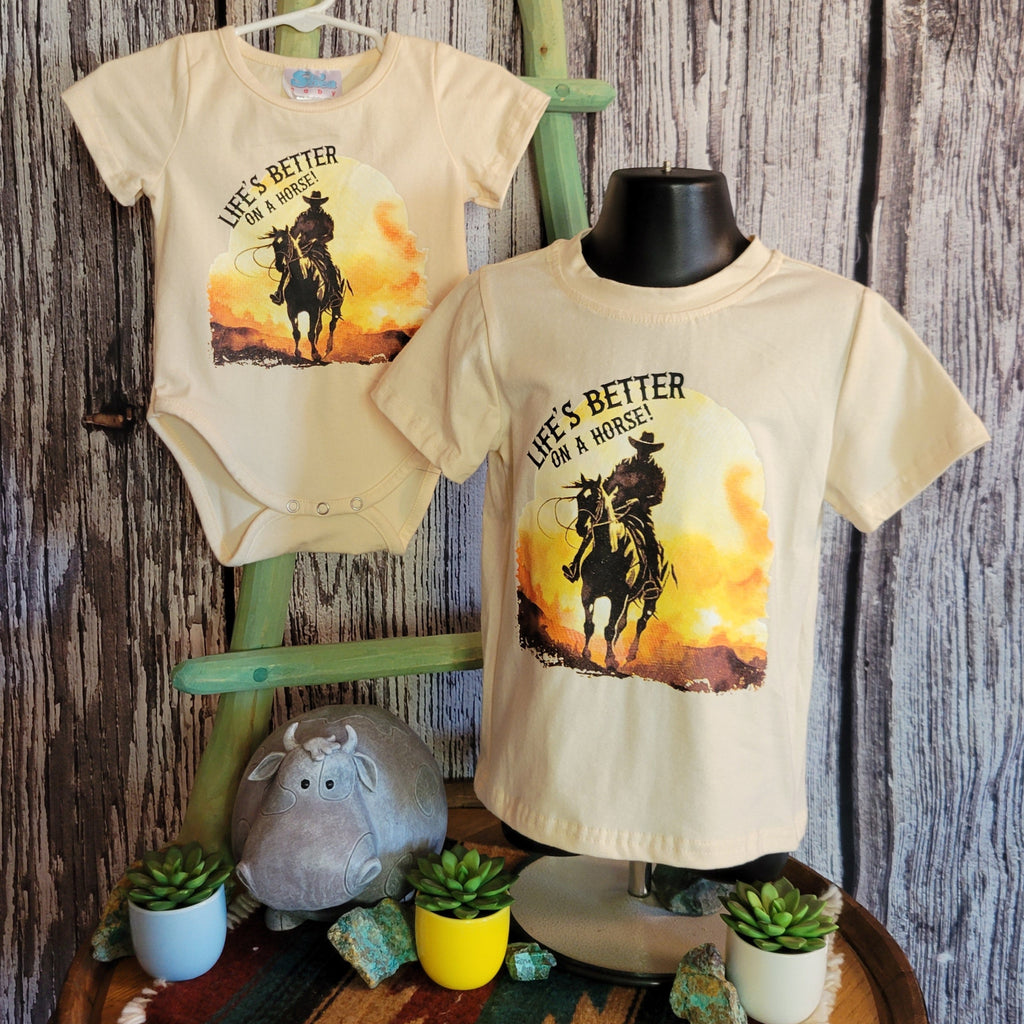 Front of both the onesie and kids' shirt with cowboy detail.