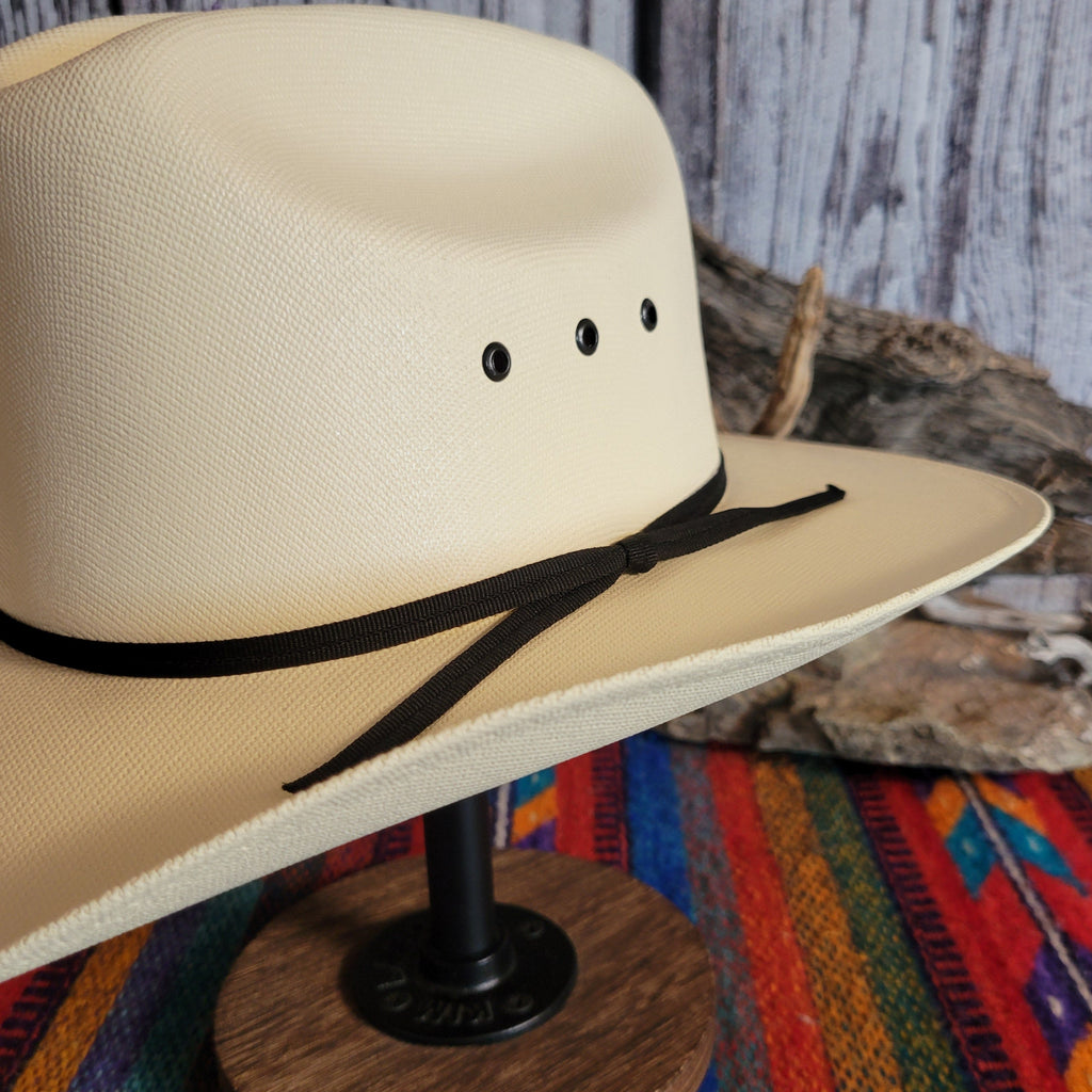 A close-up of the thin, black hat band tied at the side of the hat.