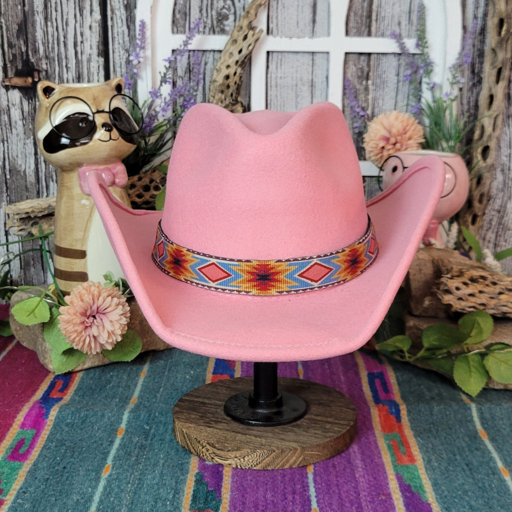 Pink wool kids' hat with a colorful geometric band.