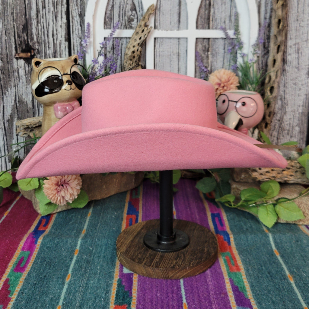 Pink wool kids' hat with a curved brim.