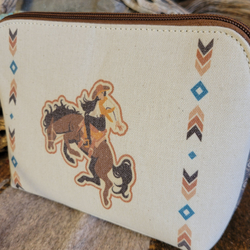 Canvas pouch with cowgirl design and southwestern print.