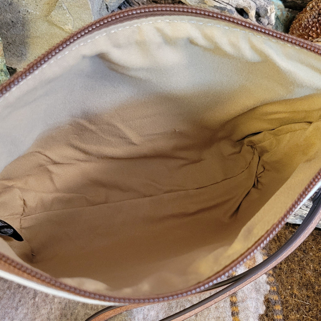 Canvas pouch with cowgirl design and southwestern print.