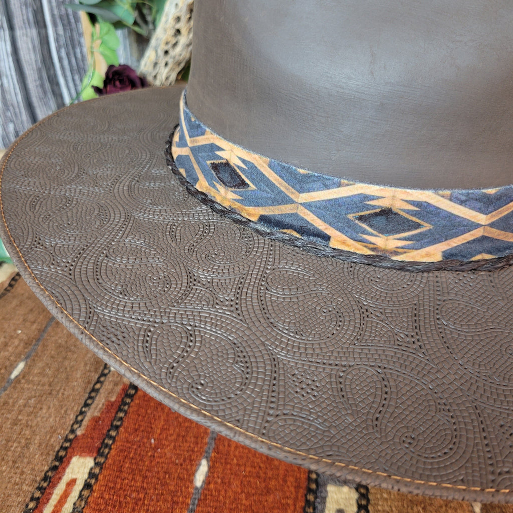 A close-up of the intricate detailing on the brim of the hat.