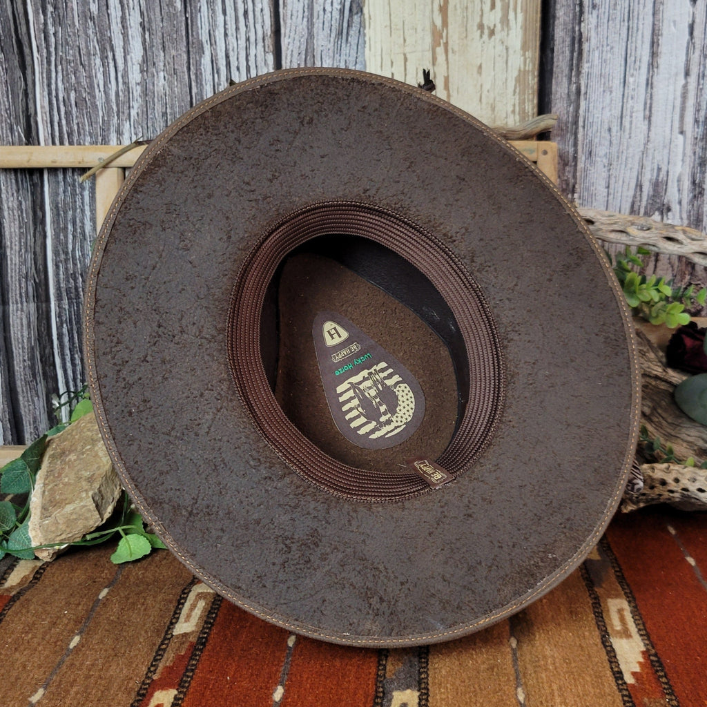 The interior of the hat showcases the brown sweatband and brand's logo.