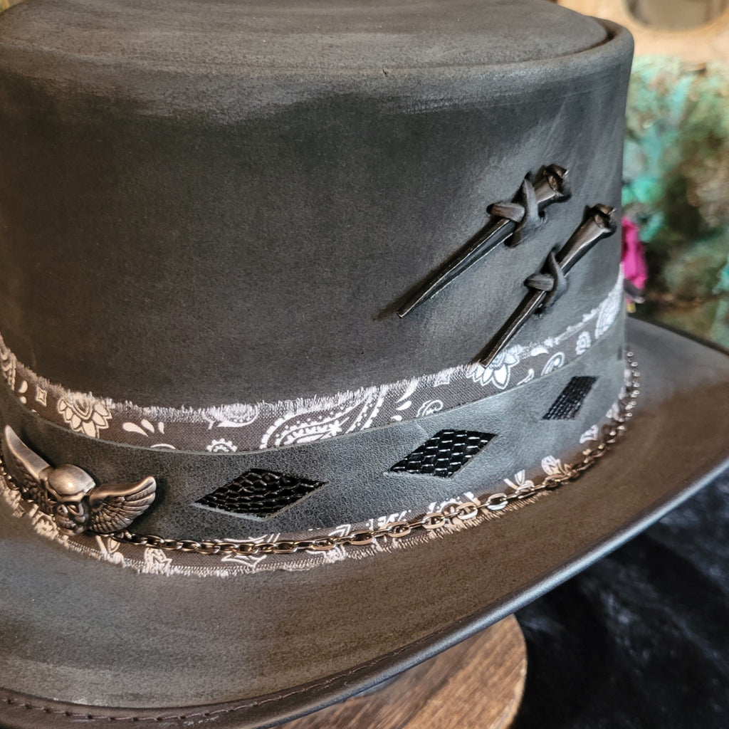 Close up of the nails tied into the leather hat's side and leather inlays.